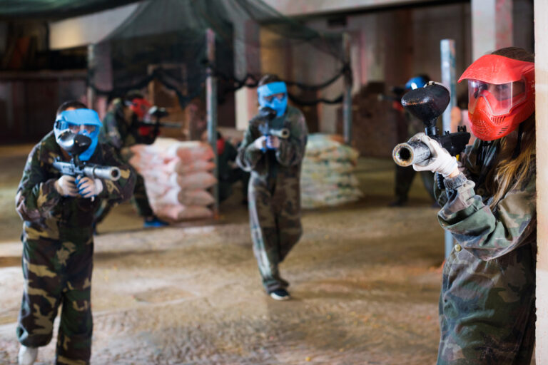 Three people playing a paintball barcelona experience
