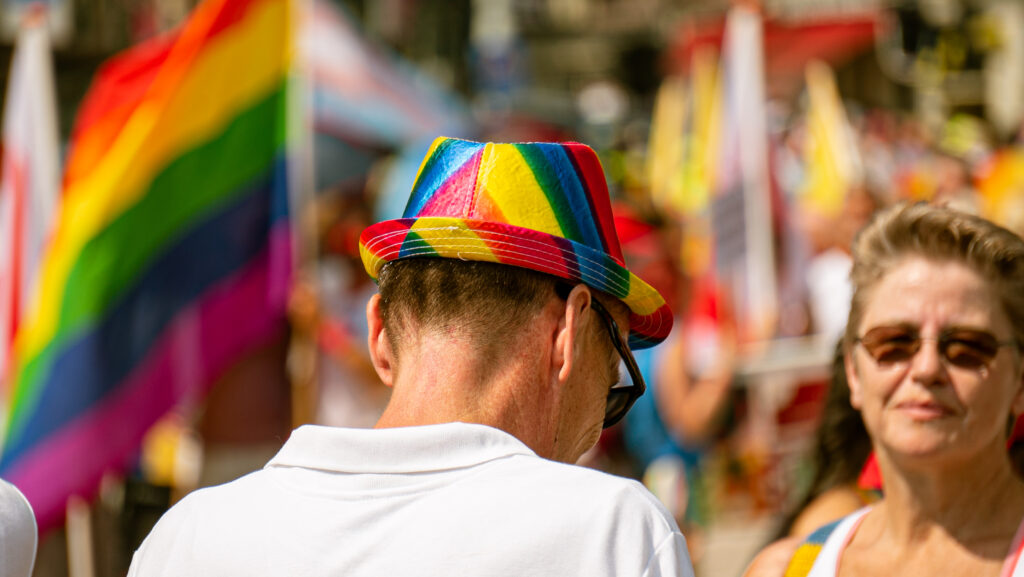 Person with a rainbow coloured hat during the pride walk Amsterdam