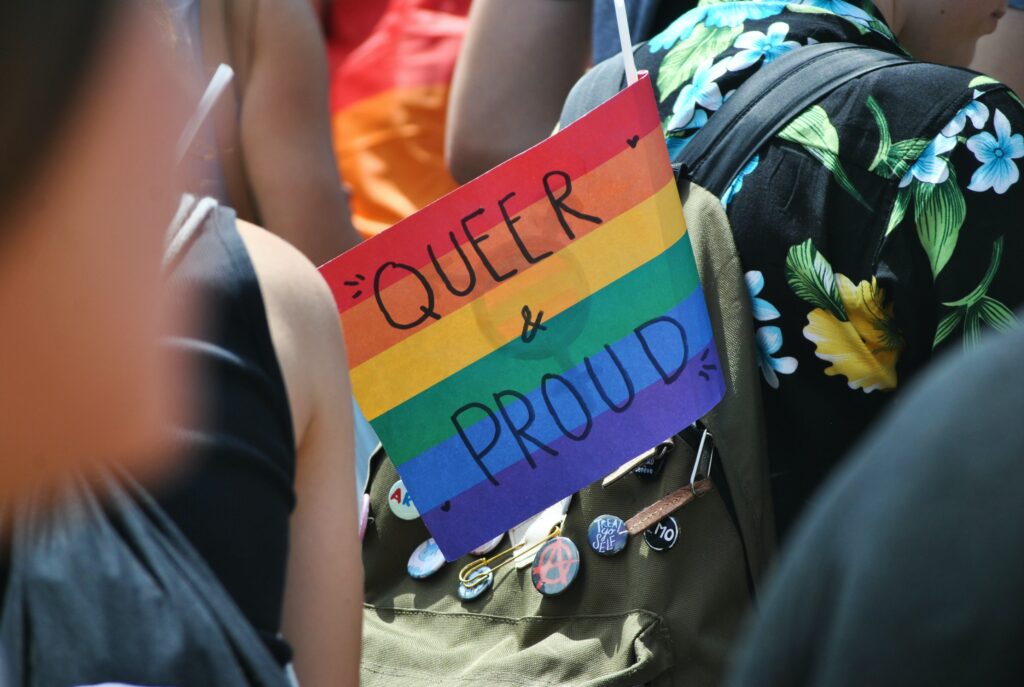 Pride Amsterdam flag with 'queer and pride' written on it. 