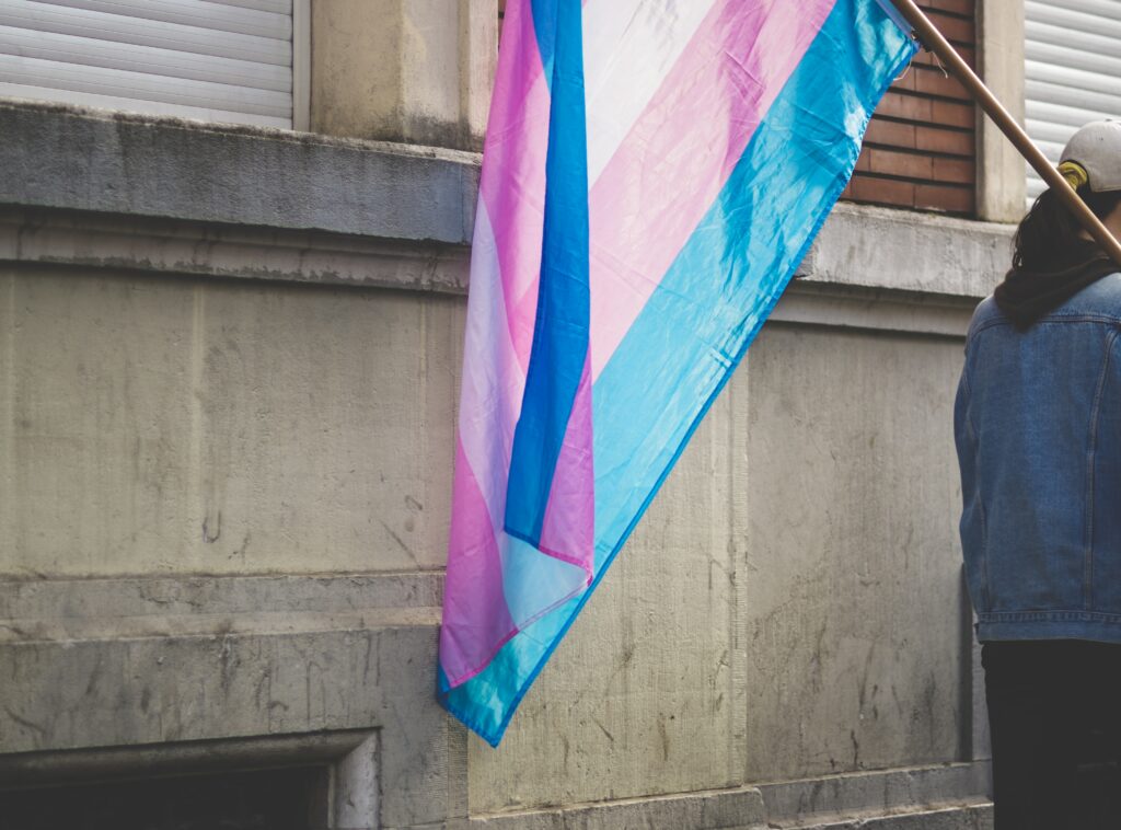 A person holding a queer flag